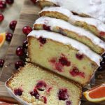 Overhead photo of a sliced Orange Cranberry Bread with an orange glaze.