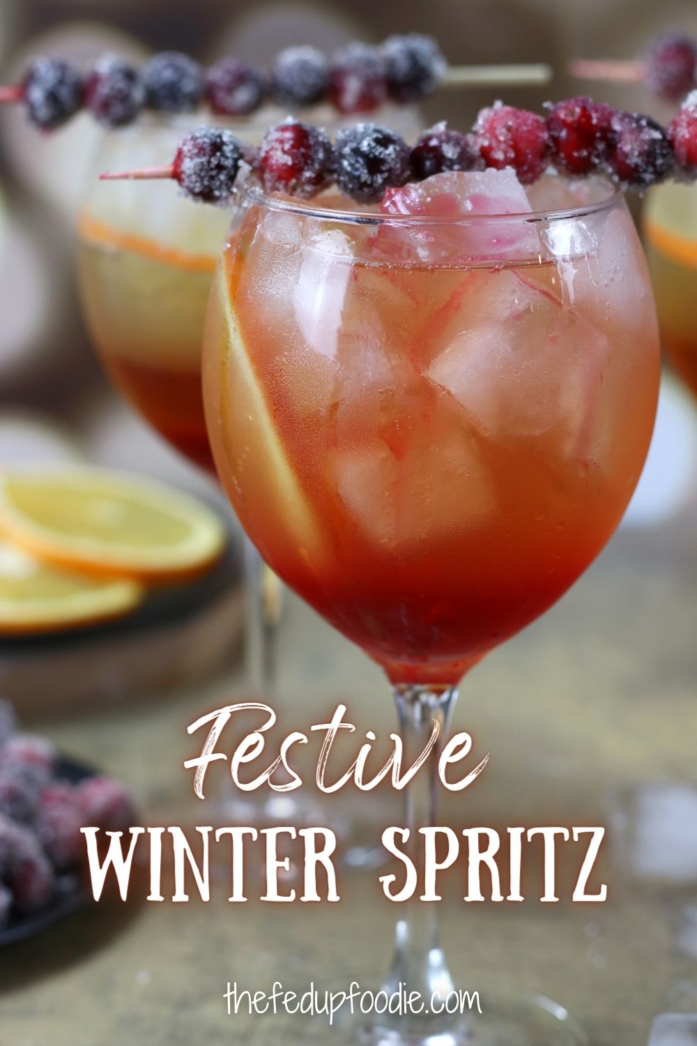 With orange liqueur, cranberry simple syrup, Prosecco and sparkling water, this Winter Spritz is a festive drink for Christmas, New Years or winter parties. #WinterSpritz #WinterSpritzCocktail #ChristmasSpritzer #ChristmasSpritzerDrink #ChristmasSpritzCocktail