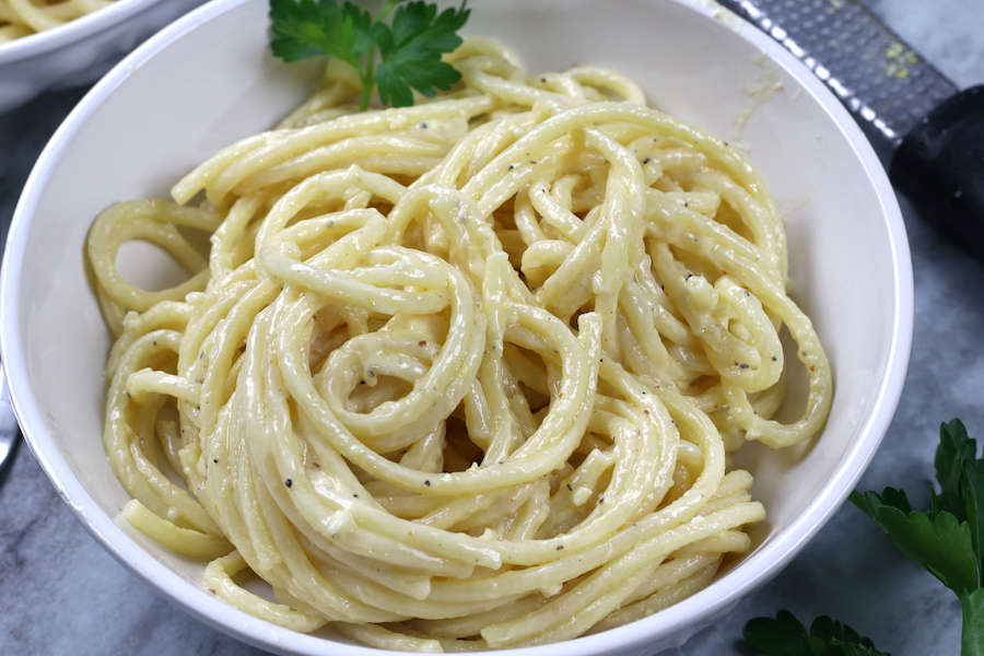 Bucatini pasta covered in Creamy Alfredo Sauce.