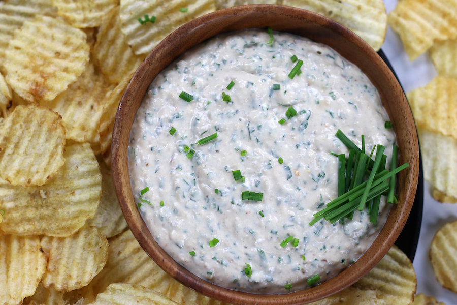 a bowl of Onion and Garlic Dip with potato chips.