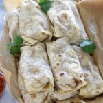 Overhead photos of Frozen Bean and Cheese Burritos piled in a roasting pan before freezing.