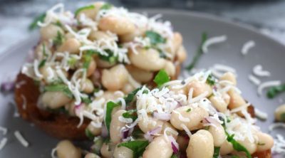 Marinated White Beans on olive oil toast and garnished with freshly grated parmesan.