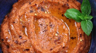 Overhead photo of Roasted Red Pepper Dip in a blue bowl.