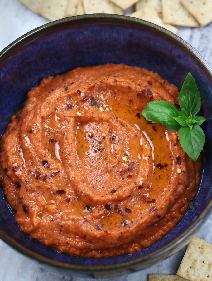 Overhead photo of Roasted Red Pepper Dip in a blue bowl.