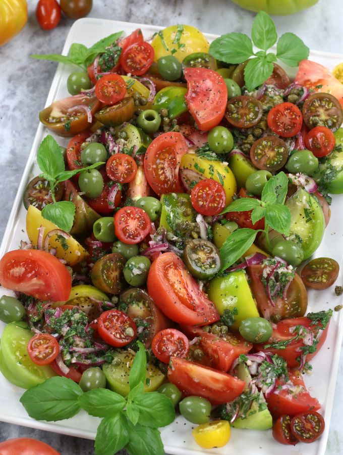 Overhead photo of Heirloom Tomato Salad on a rectangle platter.