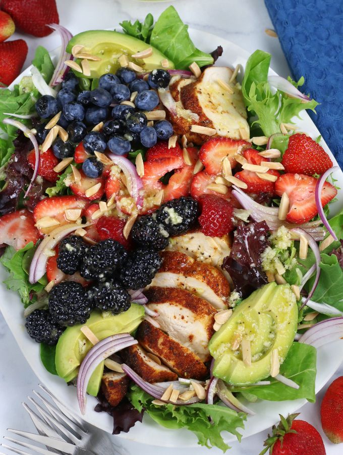 Overhead photo of a platter of Chicken Berry Salad with avocado and almond slivers.