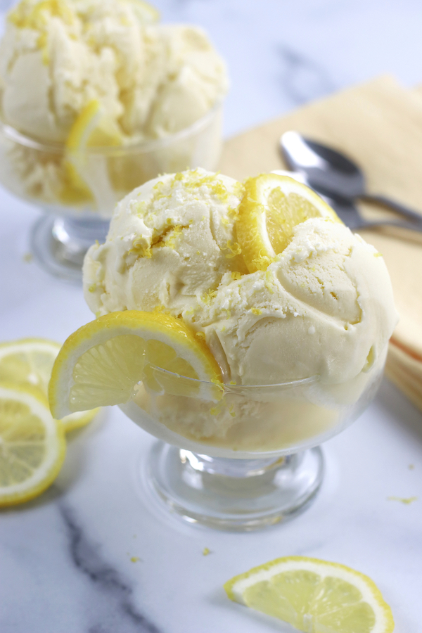 3 scoops of Lemon Custard Ice Cream served in a glass ice cream dish.