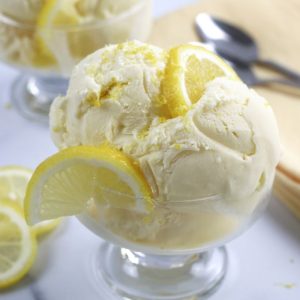 Lemon Ice Cream garnished with lemon slices and lemon zest.