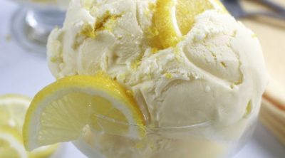 Lemon Ice Cream garnished with lemon slices and lemon zest.