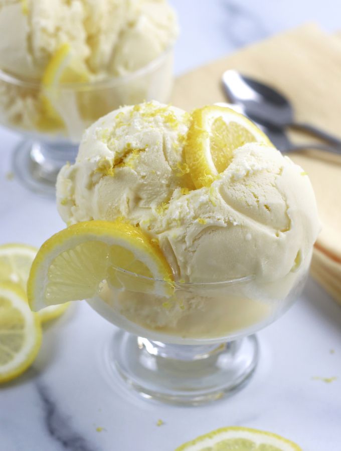 Lemon Ice Cream garnished with lemon slices and lemon zest.