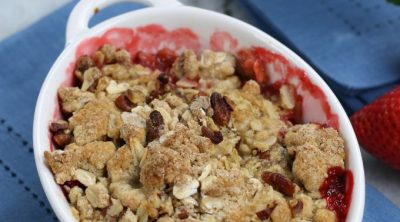 Strawberry Crumble in a white ramekin sitting on a blue napkin.