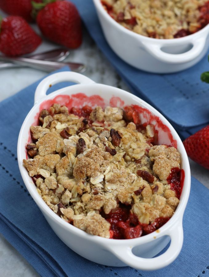 Strawberry Crumble in a white ramekin sitting on a blue napkin.