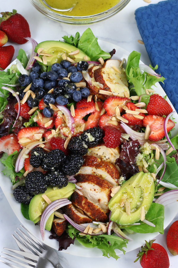 A larger plate of Summer Chicken Salad with blueberries, blackberries and strawberries.