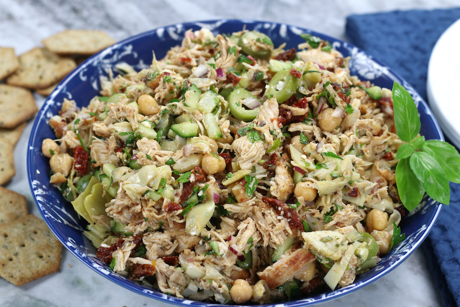 Chicken Salad Recipe with olive oil and no-mayo served in a bowl surrounded by crackers.