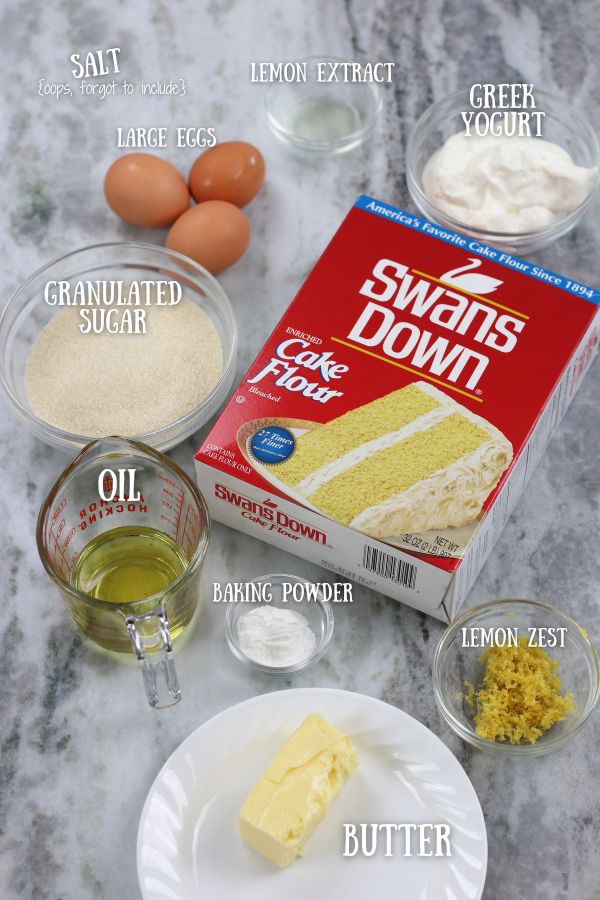 Ingredients for Lemon Sheet Cake arranged on a white marble countertop.