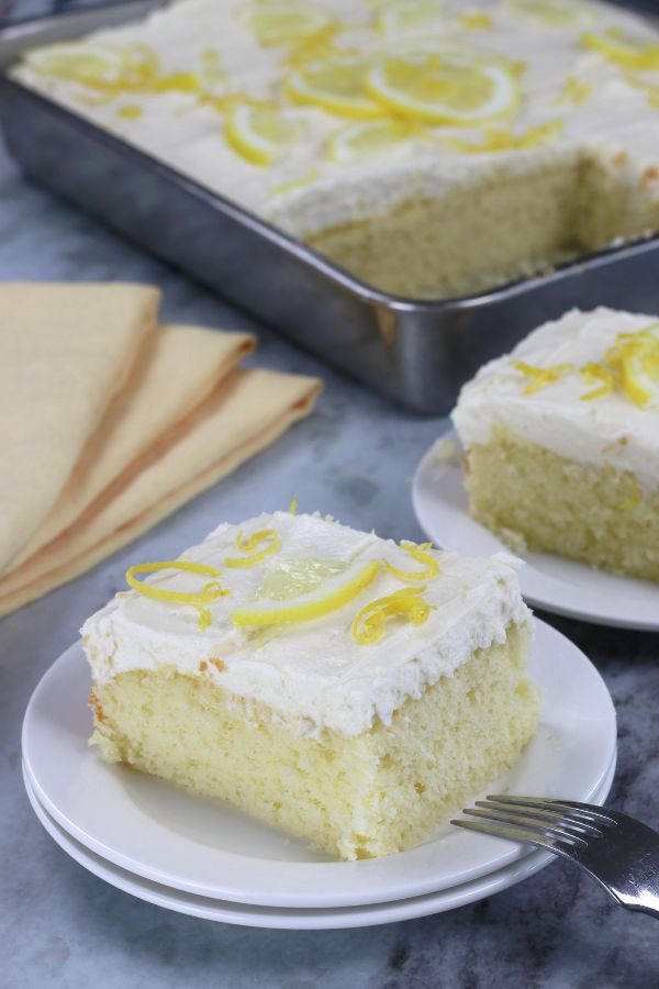 Lemon Cake with Cream Cheese Frosting served next to yellow cloth napkins.