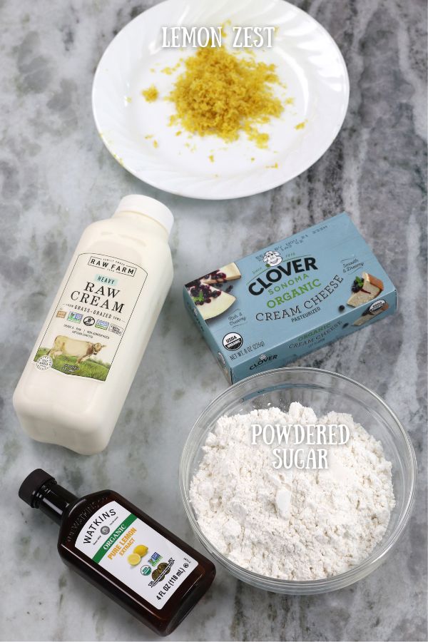 Lemon Cream Cheese Frosting Ingredients arranged on a white marble countertop.