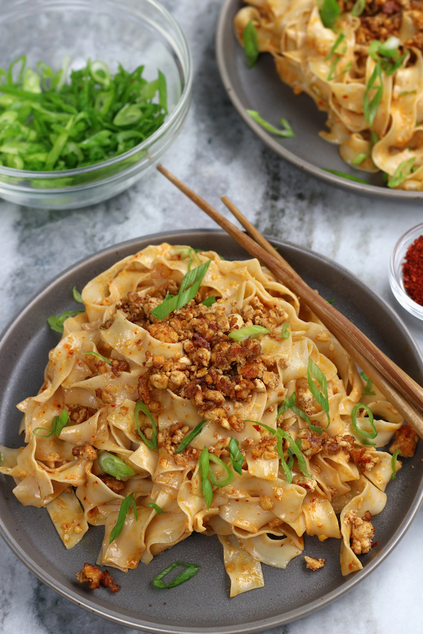 Overhead photo of Miso Taiwanese Noodles served on a grey plate sitting on a white marble countertop.