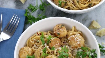 Overhead photo of Scallop Linguine served in white bowls.