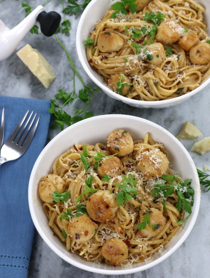 Overhead photo of Scallop Linguine served in white bowls.