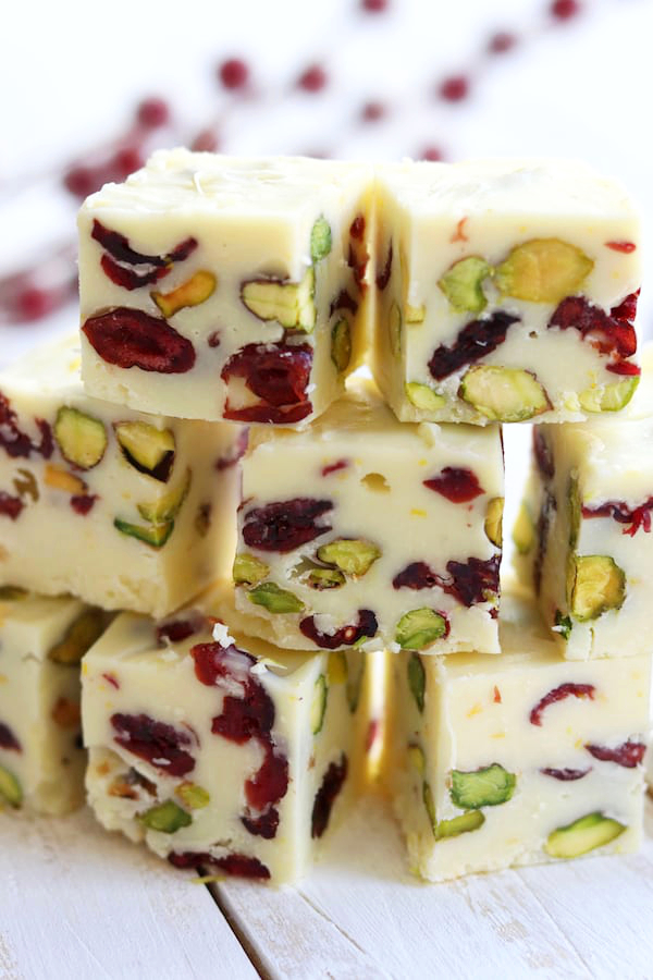White Chocolate Cranberry Fudge pieces stacked three high.