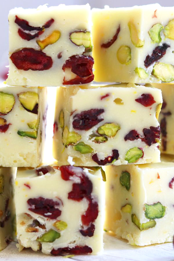 White Fudge with cranberries and pistachios stacked on top of each other.