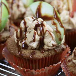 Applesauce Cupcakes with a Caramel Buttercream Frosting sitting on a cooling rack.