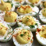 Up close photo of Classic Deviled Eggs garnished with fresh chopped chives.