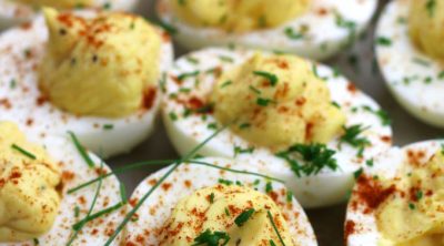 Up close photo of Classic Deviled Eggs garnished with fresh chopped chives.