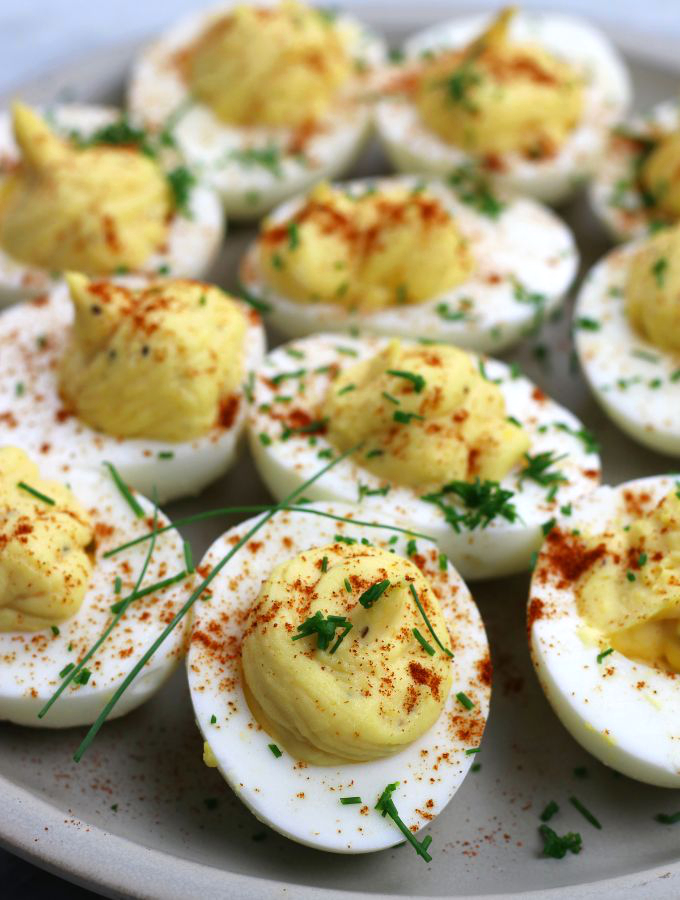 Up close photo of Classic Deviled Eggs garnished with fresh chopped chives.