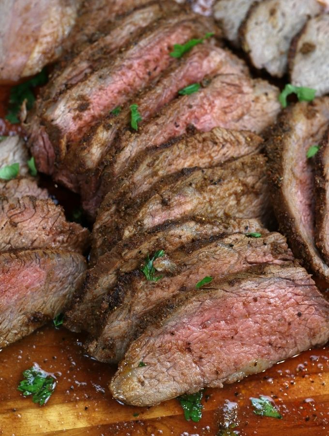 Oven Roasted Tri-Tip sliced on a wooden cutting board.