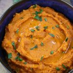 Savory Whipped Sweet Potatoes garnished with freshly chopped parsley.