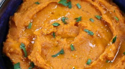 Savory Whipped Sweet Potatoes garnished with freshly chopped parsley.