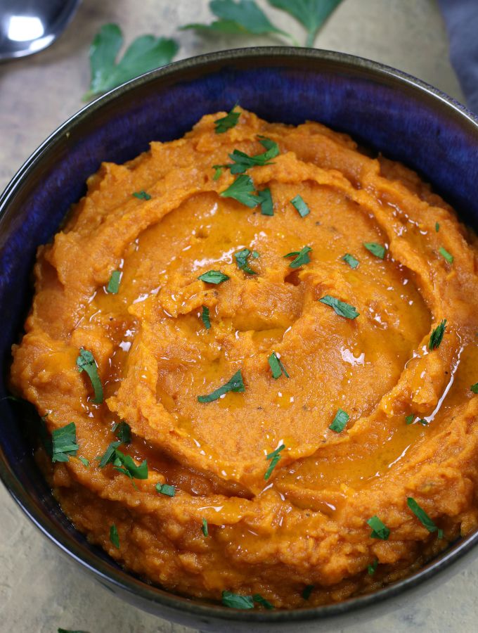 Savory Whipped Sweet Potatoes garnished with freshly chopped parsley.