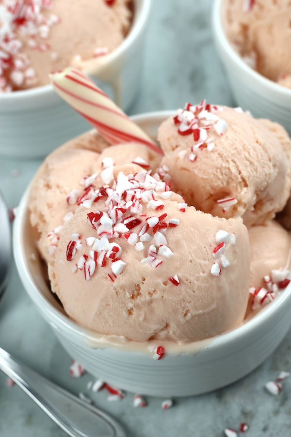 A close-up shot featuring a bowl of Peppermint Ice Cream Recipe positioned alongside a spoon.