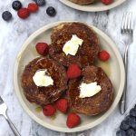 Overhead photo of plated French Toast on Sourdough Bread sitting on a white marble countertop.