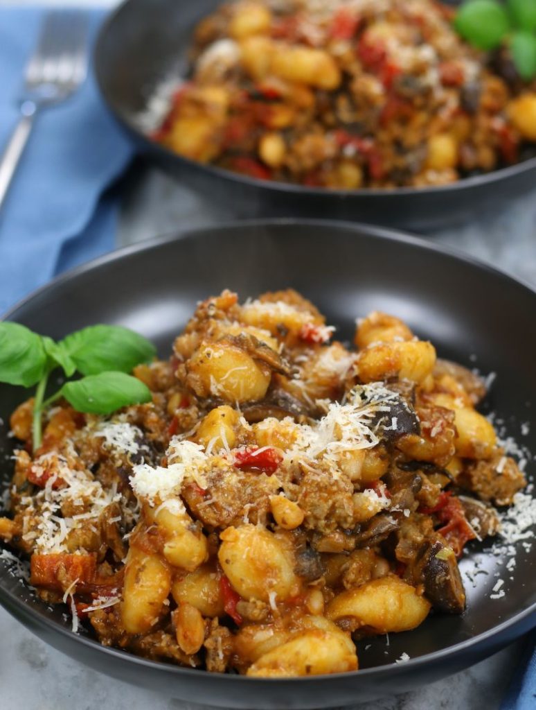 Italian Goulash with homemade Italian sausage served in two black bowls.