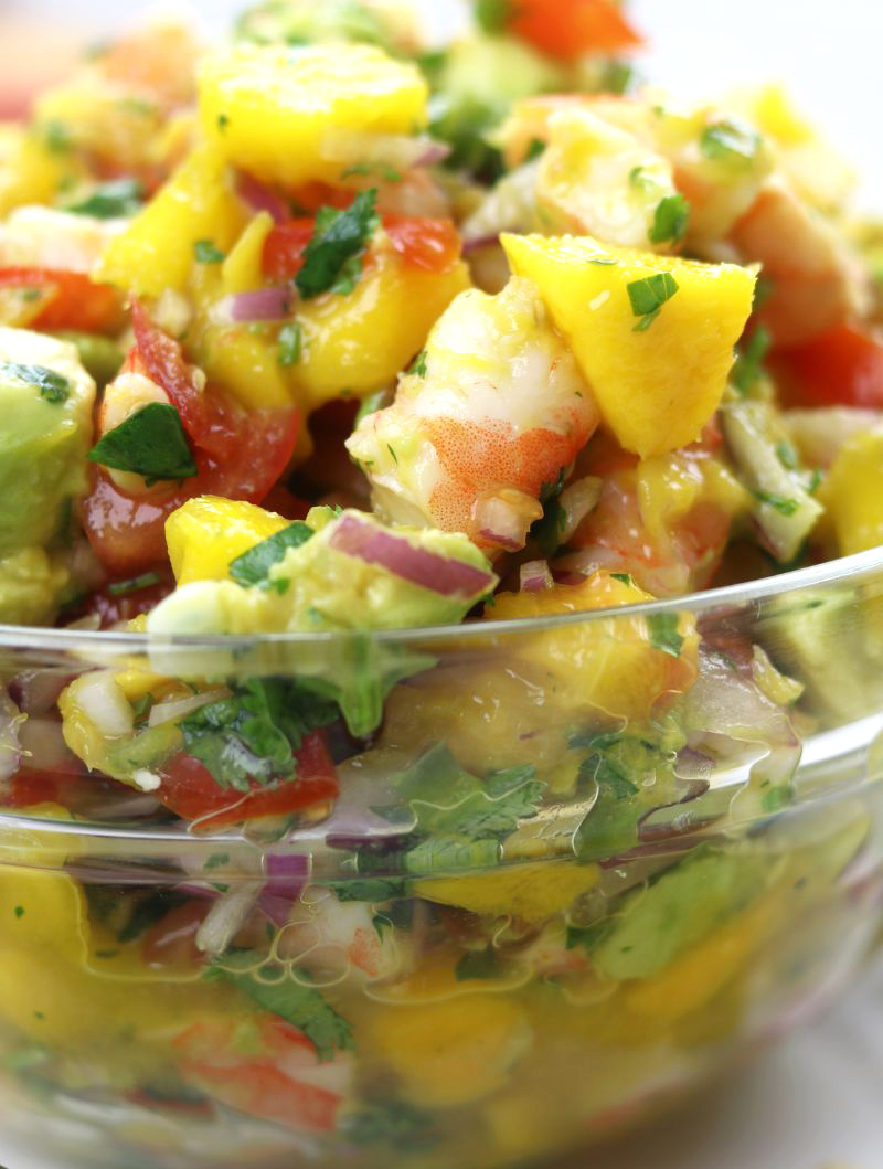 Up close photo of Mango Shrimp Salsa in a clear glass bowl.