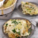 Creamy Scalloped Potatoes served on two small plates.