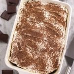 Easy Chocolate Sheet Cake sprinkled with chocolate shavings and surrounded with chocolate chunks.