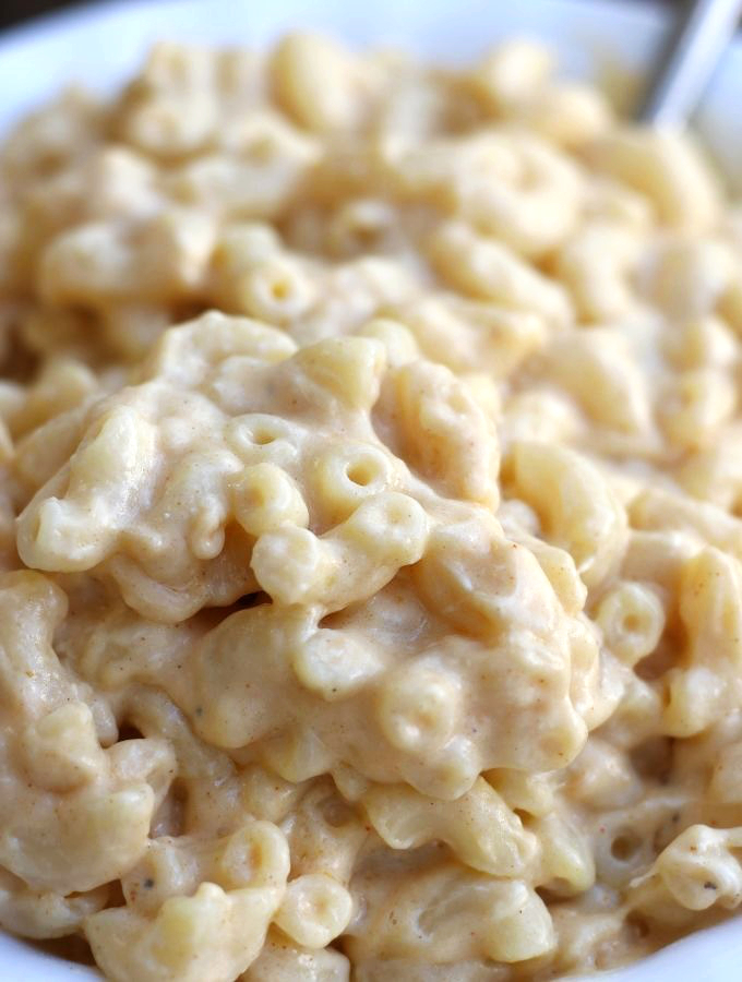 A close-up bowl of Creamy Mac and Cheese showing tender pasta coated in a rich, smooth cheese sauce.