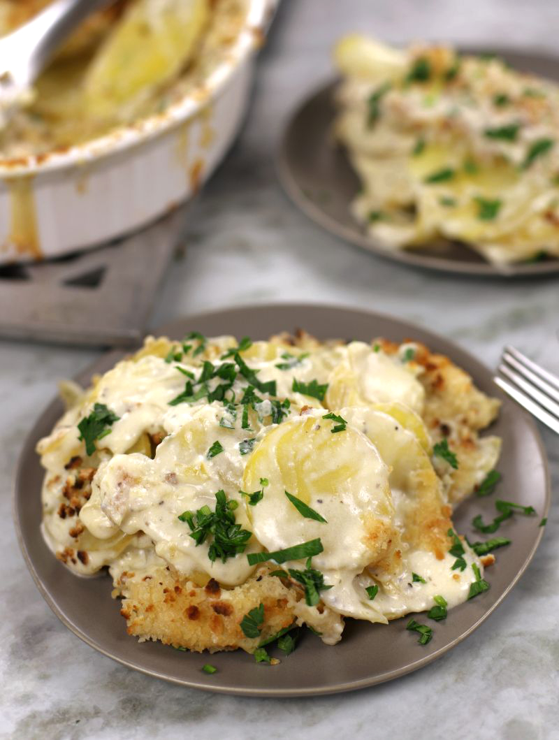 Creamy Scalloped Potatoes served on two small plates.