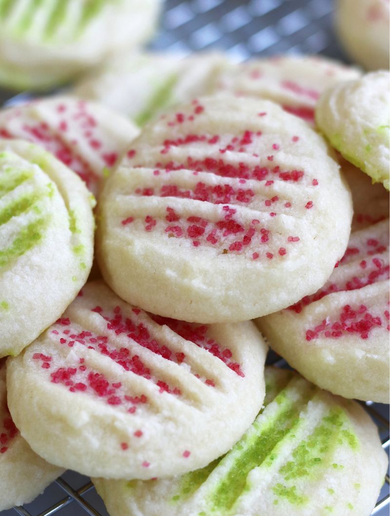 Up close photo of Whipped Shortbread Cookies with red and green sprinkles.