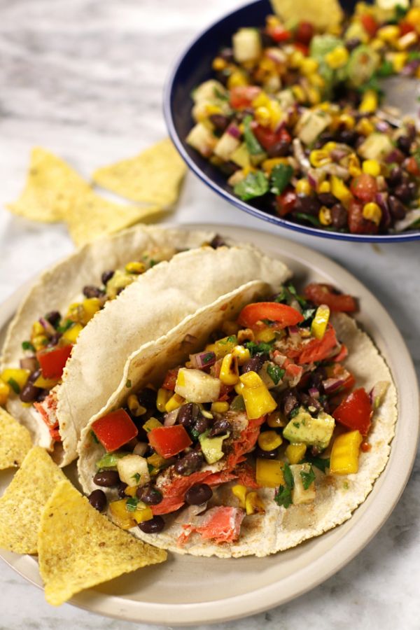 Black Bean Corn Salad served in a two soft tacos with baked salmon.
