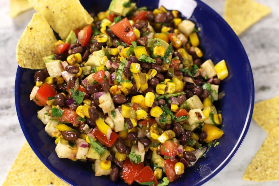 Overhead photo of Black Bean Salad Recipe with Corn in a bowl surrounded with tortilla chips.