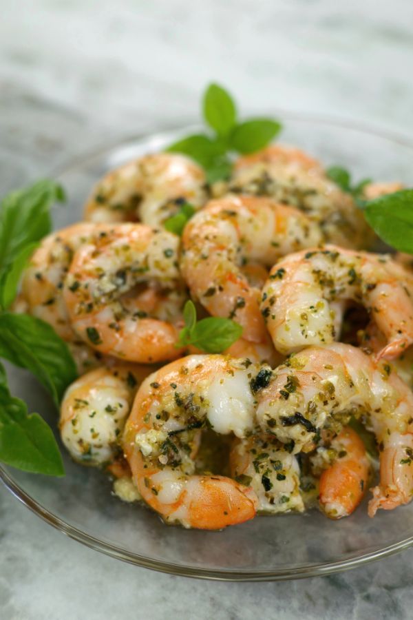Large Oven Roasted Shrimp tossed in garlic and herbs, garnished with fresh basil.